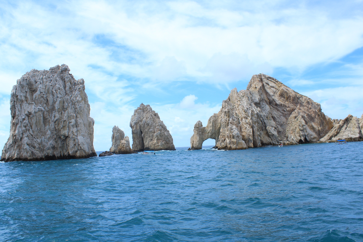 The Arch and the rock formations of Land's End seen from a charter boat